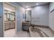 Bathroom with double vanity, bath tub, modern fixtures, and ample lighting at 4662 Long Lake Dr, Sarasota, FL 34233
