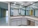 Elegant bathroom with double vanity, granite countertop, and corner mirrors at 4662 Long Lake Dr, Sarasota, FL 34233
