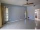 Bright bedroom boasts tile floors, a ceiling fan and ample natural light from the windows at 4662 Long Lake Dr, Sarasota, FL 34233