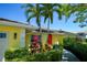 Well-maintained single-story home with a manicured lawn, mature trees, and colorful landscaping at 4662 Long Lake Dr, Sarasota, FL 34233