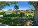 Well-maintained single-story home with a manicured lawn, mature trees, and colorful landscaping at 4662 Long Lake Dr, Sarasota, FL 34233