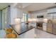 Modern kitchen with stainless steel appliances, sleek white cabinetry, and stylish counter seating at 4662 Long Lake Dr, Sarasota, FL 34233