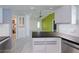 Well-lit kitchen adjacent to a living space, with updated cabinets and modern finishes at 4662 Long Lake Dr, Sarasota, FL 34233