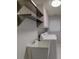 The laundry room comes equipped with a wash basin, overhead shelving, and washer-dryer hookups at 4662 Long Lake Dr, Sarasota, FL 34233