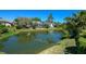 Scenic view of a serene pond surrounded by lush greenery and well-maintained landscaping at 4662 Long Lake Dr, Sarasota, FL 34233
