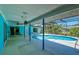 Inviting covered pool area with ample seating and lush landscaping, perfect for outdoor relaxation at 4662 Long Lake Dr, Sarasota, FL 34233