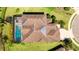 An aerial view of the roof showing a screened-in pool and well-maintained backyard at 4706 Balboa Park Loop, Bradenton, FL 34211