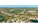 An aerial view of the home in a residential area near a lake and school at 4706 Balboa Park Loop, Bradenton, FL 34211