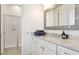 Bathroom features granite countertop, a decorative mirror, and a glass-door shower with subway tile at 4706 Balboa Park Loop, Bradenton, FL 34211