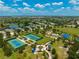 Aerial view of community park with tennis courts, playground, picnic pavilions, and walking trails at 4706 Balboa Park Loop, Bradenton, FL 34211