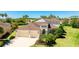 Beautiful two-story home with a three-car garage and manicured front lawn, set amongst swaying palm trees at 4706 Balboa Park Loop, Bradenton, FL 34211