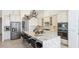 Bright and modern kitchen with stainless steel appliances, granite countertops, and a spacious center island with barstool seating at 4706 Balboa Park Loop, Bradenton, FL 34211
