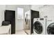 Laundry room with stainless steel fridge, modern washer and dryer, and a large window at 4706 Balboa Park Loop, Bradenton, FL 34211