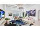 Expansive living room featuring high ceilings, unique artwork, and an open layout that seamlessly connects to the outdoor patio at 4706 Balboa Park Loop, Bradenton, FL 34211