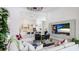 Bright living room with open floor plan leading to the kitchen, featuring stylish decor and modern entertainment center at 4706 Balboa Park Loop, Bradenton, FL 34211