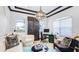 Sophisticated home office featuring a decorative chandelier, custom built-ins and lots of natural light at 4706 Balboa Park Loop, Bradenton, FL 34211