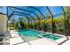 A stunning screened-in pool features sparkling turquoise water and a heated spa at 4706 Balboa Park Loop, Bradenton, FL 34211