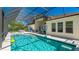 A stunning screened-in pool features sparkling turquoise water and a fun basketball hoop at 4706 Balboa Park Loop, Bradenton, FL 34211