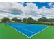 Inviting tennis court with blue and green surfaces for active recreation and community engagement at 4706 Balboa Park Loop, Bradenton, FL 34211