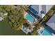 Waterfront property boasting a stunning pool, a dock, and lush tropical landscaping from an aerial perspective at 4922 Commonwealth Dr, Sarasota, FL 34242