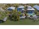 Aerial view showcasing the waterfront property with a pool, a dock, and lush landscaping at 4922 Commonwealth Dr, Sarasota, FL 34242