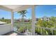 Balcony with beautiful view of a waterway surrounded by houses and palm trees at 4922 Commonwealth Dr, Sarasota, FL 34242