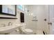Modern bathroom featuring a glass shower, pedestal sink, and sleek white subway tile at 4922 Commonwealth Dr, Sarasota, FL 34242
