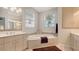 Bathroom featuring a soaking tub, decorative tile, and a window at 4922 Commonwealth Dr, Sarasota, FL 34242