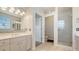 Bright bathroom featuring tile floors, a double vanity, and a walk-in shower at 4922 Commonwealth Dr, Sarasota, FL 34242
