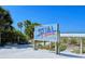 Siesta Beach sign framed by lush greenery and palm trees, inviting visitors to its pristine shores at 4922 Commonwealth Dr, Sarasota, FL 34242