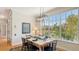 Dining room highlighting a set dining table near a large window with natural lighting at 4922 Commonwealth Dr, Sarasota, FL 34242