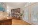 Inviting entryway with warm hardwood floors and a bookshelf, providing ample storage at 4922 Commonwealth Dr, Sarasota, FL 34242