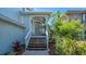 Front porch featuring a decorated entrance, landscaped surroundings, and a brick paver walkway at 4922 Commonwealth Dr, Sarasota, FL 34242