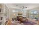 Comfortable living room with bookshelves and access to the outdoor screened-in porch at 4922 Commonwealth Dr, Sarasota, FL 34242