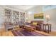 Bright living room featuring built-in bookshelves and hardwood floors at 4922 Commonwealth Dr, Sarasota, FL 34242