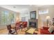 Comfortable living room featuring a fireplace, hardwood floors, and natural light from windows at 4922 Commonwealth Dr, Sarasota, FL 34242