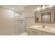 Modern bathroom featuring a tiled walk-in shower, white vanity, and ample lighting at 5078 Marsh Field Rd # 82, Sarasota, FL 34235
