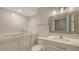 Bright bathroom features a walk-in tub, white vanity, and neutral color palette at 5078 Marsh Field Rd # 82, Sarasota, FL 34235