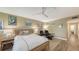 Light-filled bedroom with stylish decor, ceiling fan, and modern wood-style flooring at 5078 Marsh Field Rd # 82, Sarasota, FL 34235