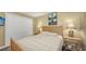Cozy bedroom featuring a wood bed frame, ceiling fan, and closet space at 5078 Marsh Field Rd # 82, Sarasota, FL 34235
