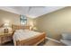 Comfortable bedroom with a ceiling fan, neutral decor, and wood-style floors at 5078 Marsh Field Rd # 82, Sarasota, FL 34235
