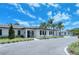 Community clubhouse featuring modern architecture, palm trees, and well-kept grounds at 5078 Marsh Field Rd # 82, Sarasota, FL 34235
