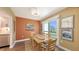 Inviting dining room featuring a wooden table, art and sliding glass door at 5078 Marsh Field Rd # 82, Sarasota, FL 34235