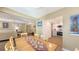 Dining room with table and 6 chairs, laminate floors, and an open view into the kitchen and living room at 5078 Marsh Field Rd # 82, Sarasota, FL 34235