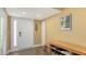 Inviting entryway featuring wood floors, bench seating and a front door with sidelight window at 5078 Marsh Field Rd # 82, Sarasota, FL 34235