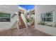 Condominium building with brick steps, white walls, and a well-maintained courtyard at 5078 Marsh Field Rd # 82, Sarasota, FL 34235