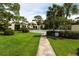 Landscaped walkway leading to the community pool, surrounded by lush green lawn at 5078 Marsh Field Rd # 82, Sarasota, FL 34235