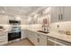 Bright kitchen with modern stainless steel appliances, white subway tile backsplash, and lots of cabinet space at 5078 Marsh Field Rd # 82, Sarasota, FL 34235