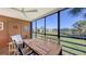 Relaxing lanai with seating area overlooking a serene lake and green landscape at 5078 Marsh Field Rd # 82, Sarasota, FL 34235