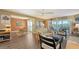 Bright living room with laminate floors, neutral tones, and a sliding glass door leading to a screened-in porch at 5078 Marsh Field Rd # 82, Sarasota, FL 34235